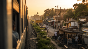 A passing train revealing an overlooked town in Bengal at golden hour.